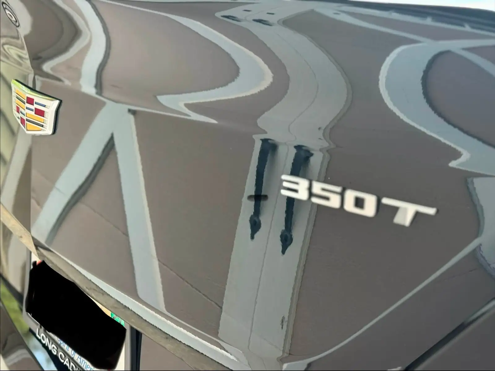 The Cadillac's 350T badge up close after the detail