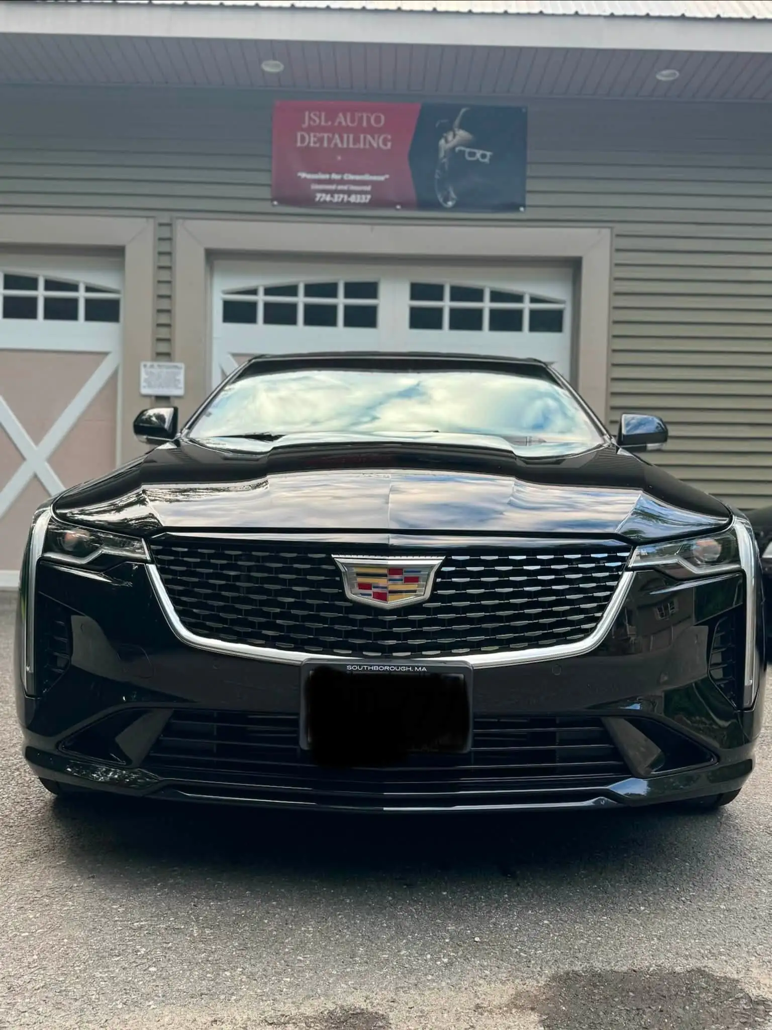 Black Cadillac CT4 from the front, outside the JSL shop