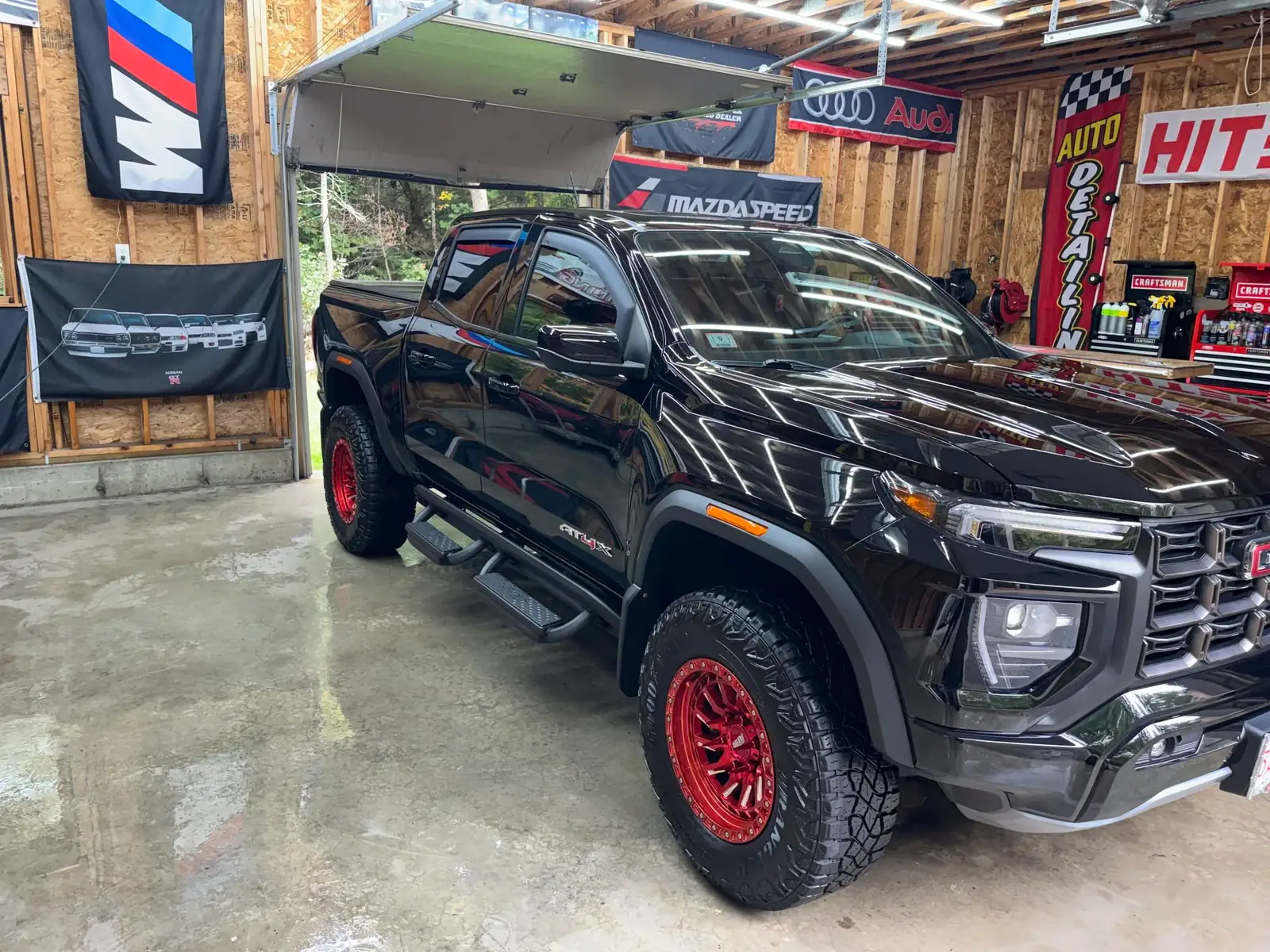 Black GMC Canyon AT4X after a detail, in the JSL shop