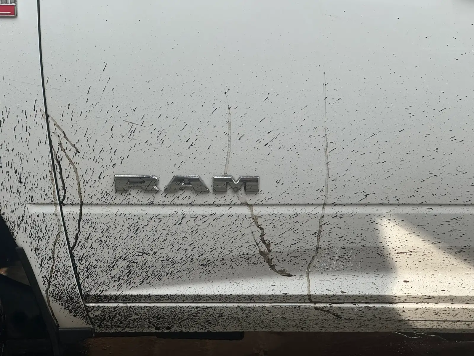 Mud spatter across the Ram's door lettering, before